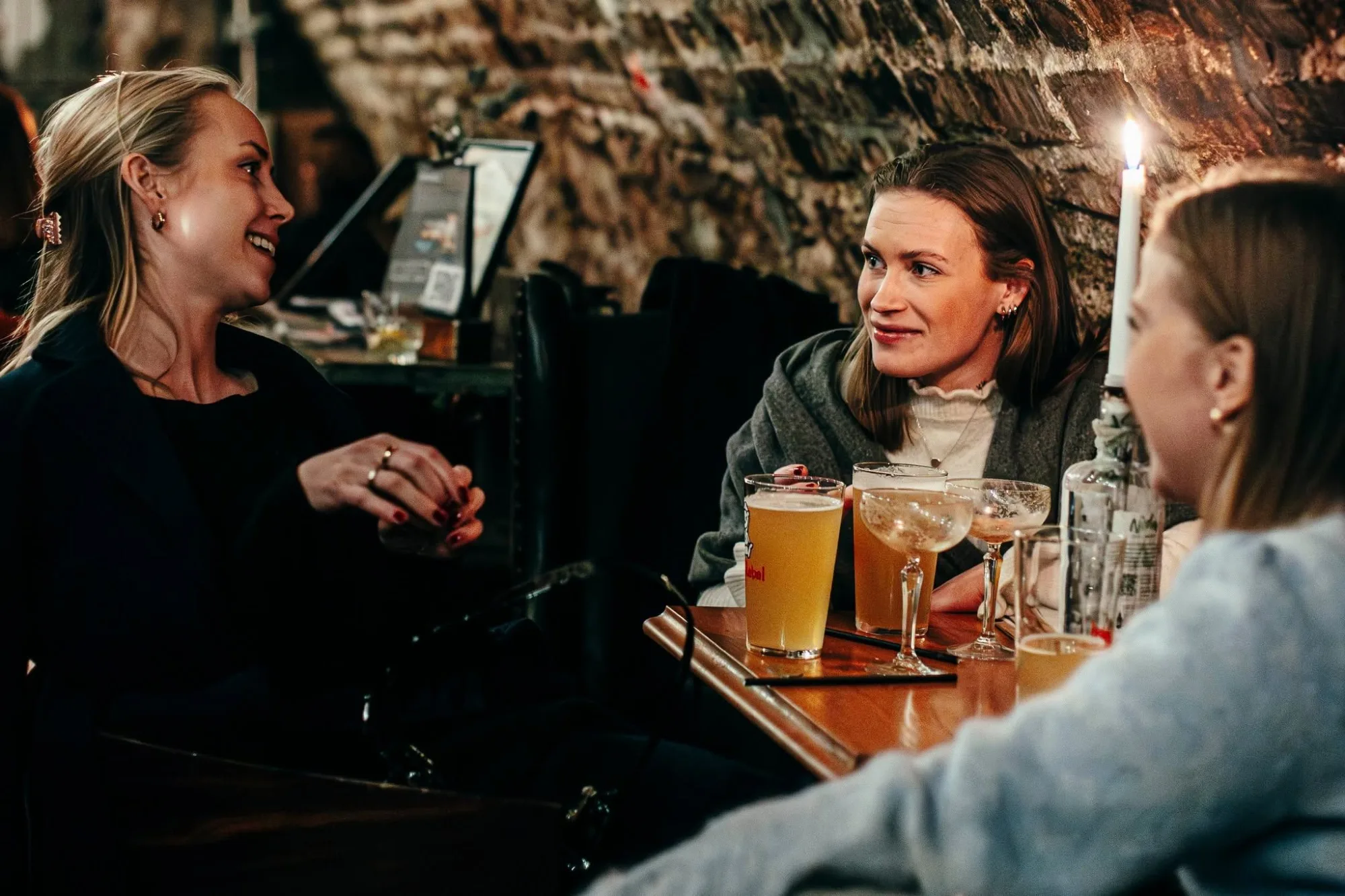 Group of friends sharing drinks at The Old Workshop bar, Aberdeen